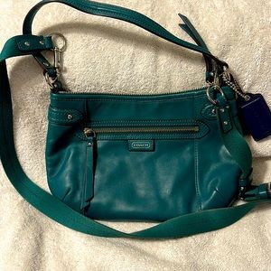 Coach teal purse with shoulder strap.